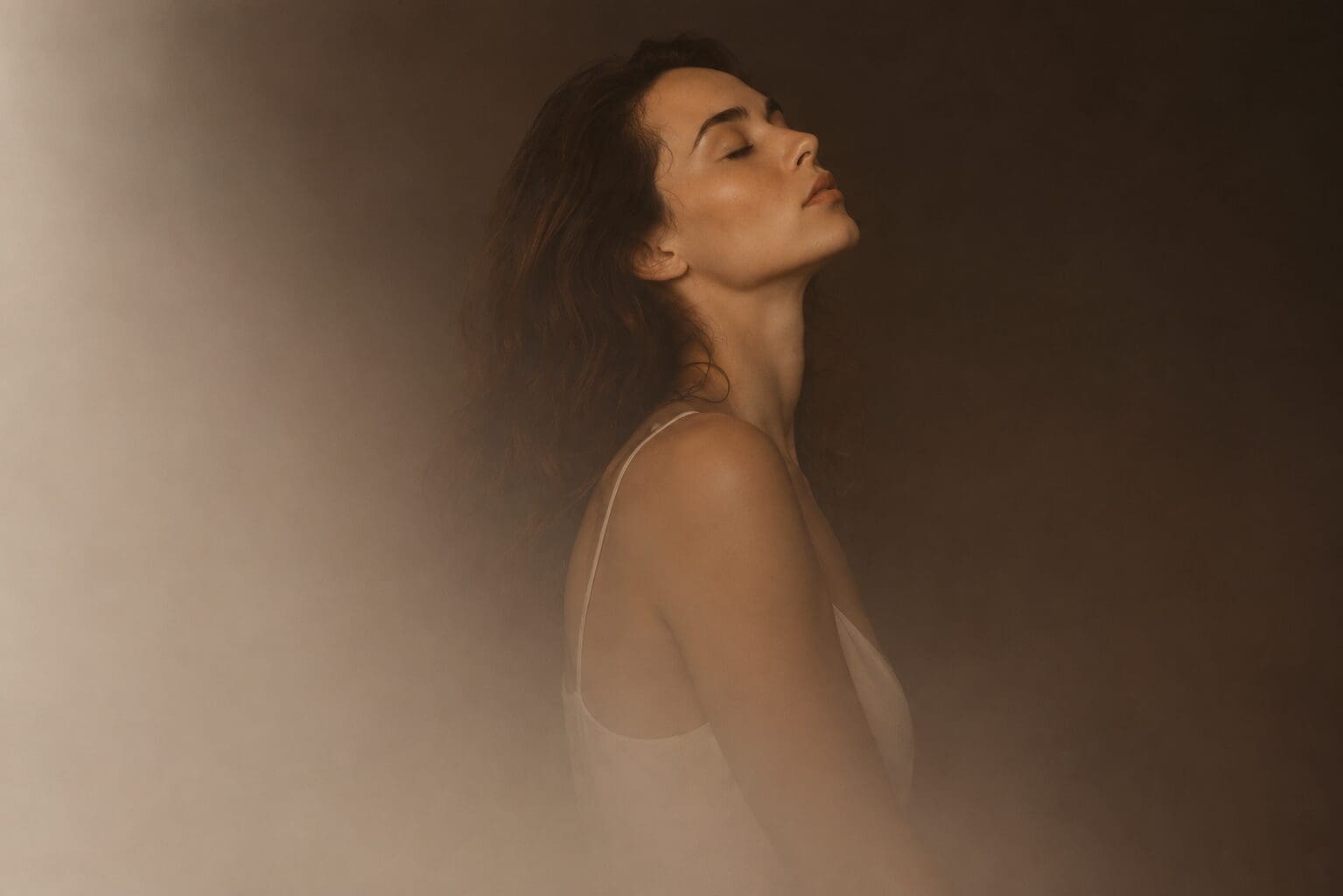 Woman with her eyes closed in soft light